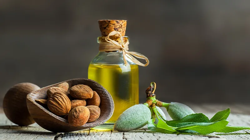 CBD Carrier Oils | CBD infused carrier oils | CBD Botanical Oils by Broad Essentials Sweet Almond seeds and a bottle of oil.